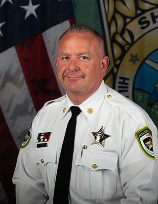 Member  

Major Chris Baumann started his career with the Sheriff’s Office in 1998 and is an FAA licensed pilot. Major Baumann has served as a deputy, field training officer, narcotics detective, and Internal Affairs detective. Before being transferred to Jail Division III as the Deputy Division Commander, Major Baumann has held supervisory positions in Patrol Districts I, II, III & IV, the Homicide Section, and the Special Investigations Division. Major Baumann obtained a Bachelor of Arts in Criminal Justice from Saint Leo University and a Master’s of Science Degree in Criminology from the University of Louisville. He is also a graduate of the 133rd Southern Police Institute Administrative Officer’s Course and completed the University of Louisville Police Executive Leadership Program in 2015.