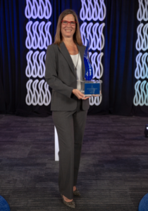 Deanna Obregon holding award